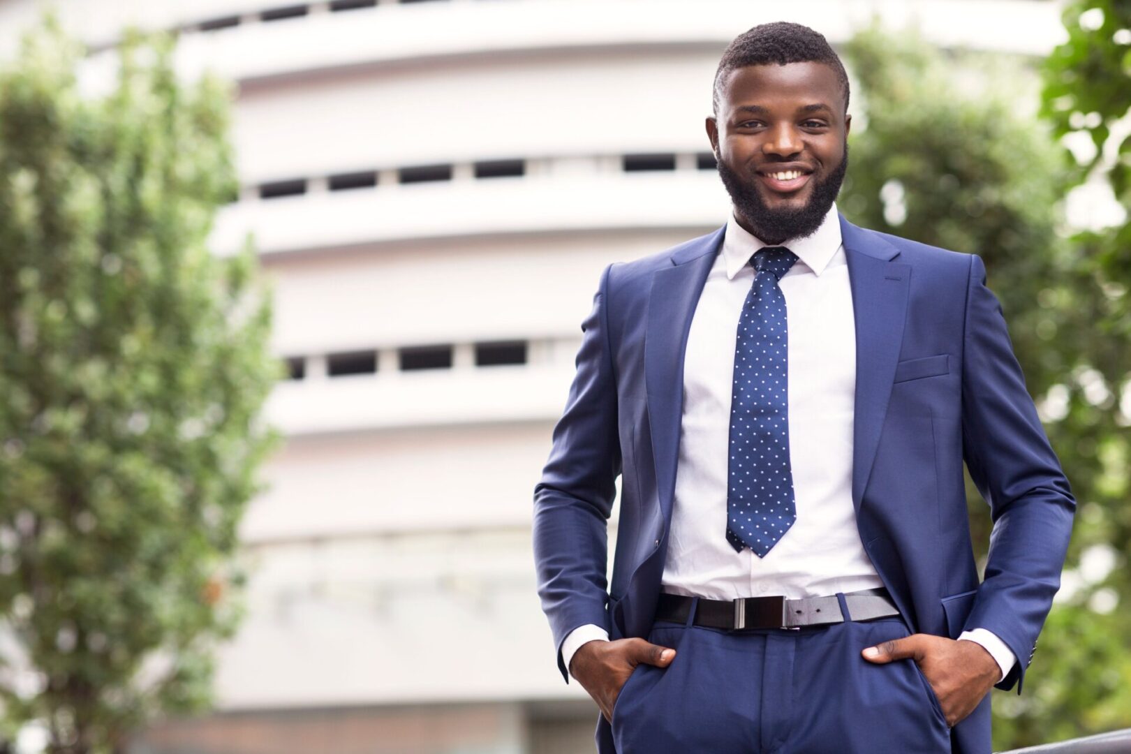 A man in a suit and tie standing outside.